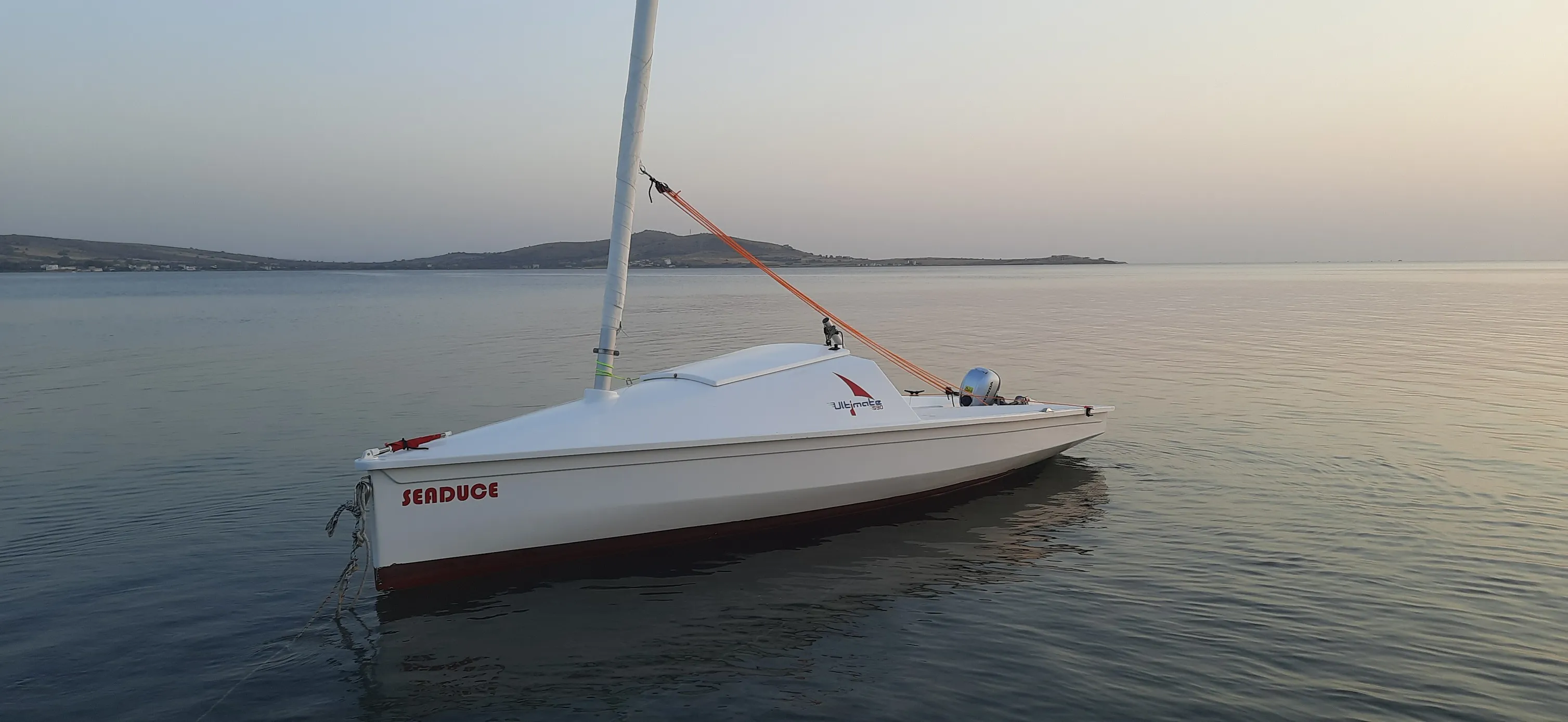 The U530 moored at golden dusk on calm, glassy water